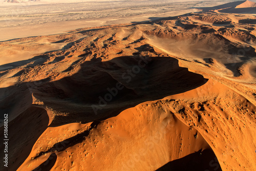Fototapeta Naklejka Na Ścianę i Meble -  Aerial of sand dunes at sunset in Namib Desert;  near Sossusvlei, Namibia