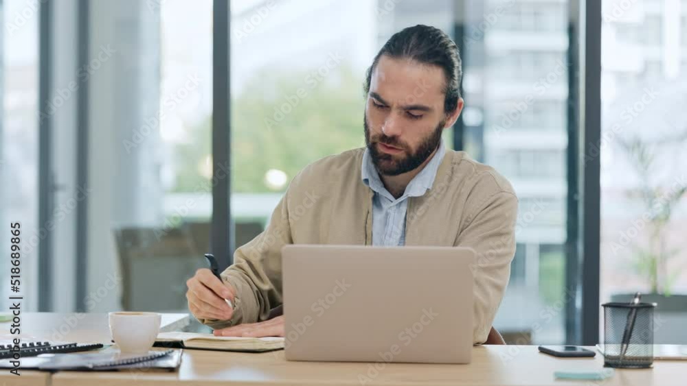 A male financial advisor or auditor attending an online or virtual meeting and writing down company details or taking notes. Accountant greeting a client on a video call from his modern office. A male financial advisor or auditor attending an online or virtual meeting and writing down company details or taking notes. Accountant greeting a client on a video call from his modern office.