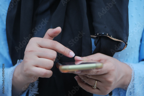 close up of women hand holding smart phone 