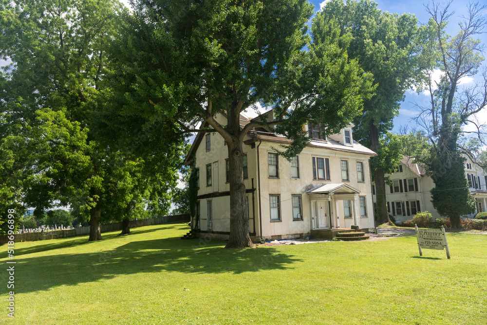 Traditional American house with a green lawn. old style.