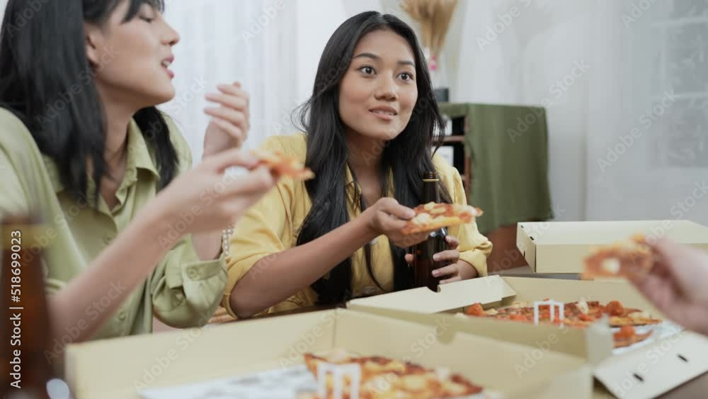 Holiday concept of 4k Resolution. Group of Asian female friends eating pizza together at home. Fun and exciting leisure activities. Holiday concept of 4k Resolution. Group of Asian female friends eating pizza together at home. Fun and exciting leisure activities.