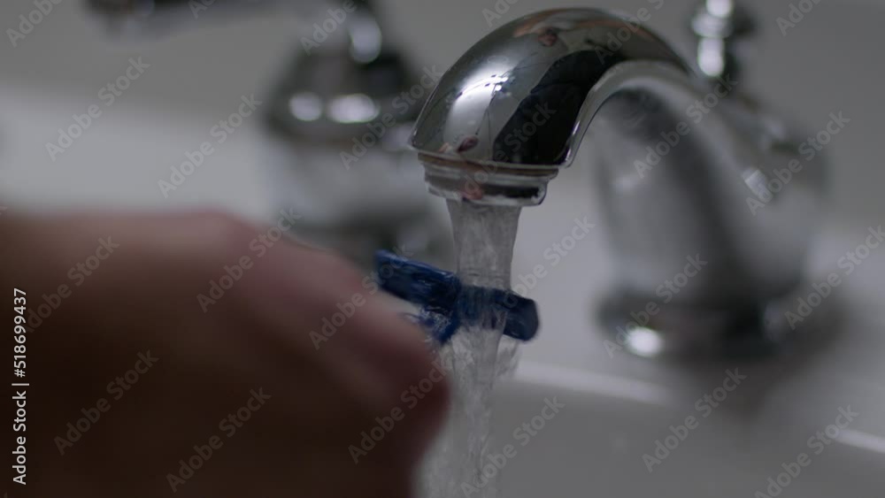 Young Caucasian Male shaving his beard during his morning routine Young Caucasian Male shaving his beard during his morning routine