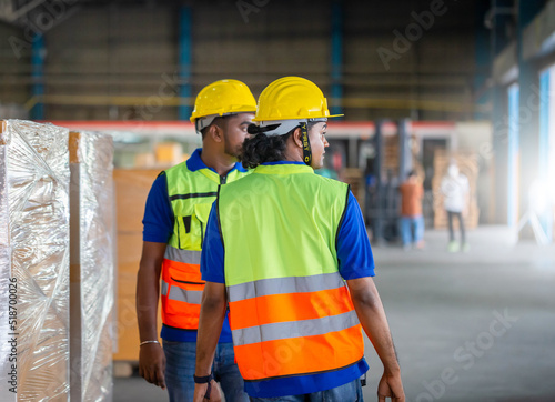 Warehouse workers working in logistics center, Workers team taking inventory in factory warehouse, Manual workers working in warehouse talking about job