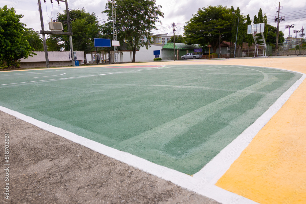 low-angle view of street basketball court with beautiful coloring floor and line shows concept of competition and winning in game for work and business. It is nobody background for sport.