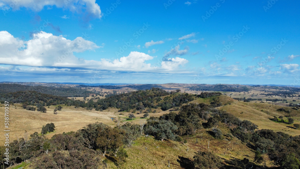 Aerial view of mountain landscape surrounded by growing trees under blue bright sky, Mudgee Australia Aerial view of mountain landscape surrounded by growing trees under blue bright sky, Mudgee Australia