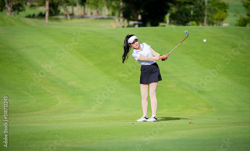 Professional woman golfer teeing golf in golf tournament competition at golf course for winner.  © APstudio