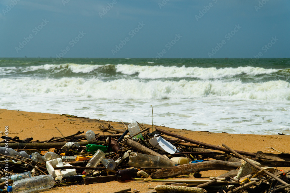 Plastic and wood waste on the beach pollute the environment. Negombo, Sri Lanka. Plastic and wood waste on the beach pollute the environment. Negombo, Sri Lanka.