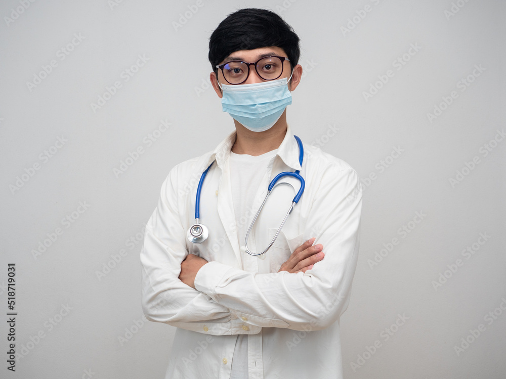 Doctor wearing medical mask and glasses standing cross arm portrait Doctor wearing medical mask and glasses standing cross arm portrait