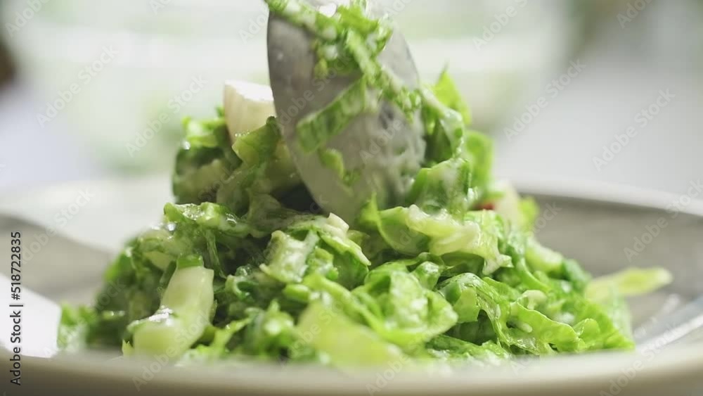 The cook serves lettuce salad with yogurt dressing.
The cook serves lettuce salad with yogurt dressing.