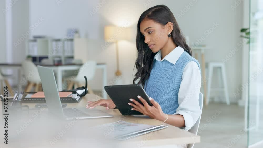 Trendy marketing professional using an online app to network, meet deadlines and stay connected during office hours. Young business woman using her laptop and tablet while working in the office. Trendy marketing professional using an online app to network, meet deadlines and stay connected during office hours. Young business woman using her laptop and tablet while working in the office.
