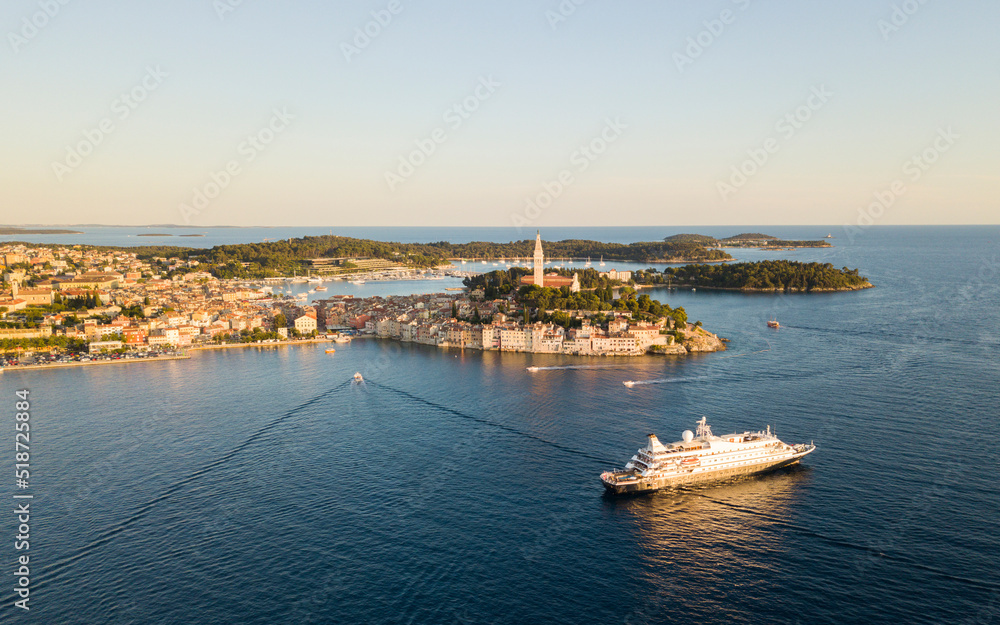 Beautiful Rovinj town (popular tourist resort and an active fishing port) at sunset. Aerial photo. The old town of Rovinj, Istria, Croatia.