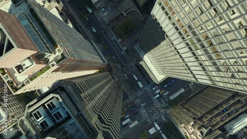 Aerial birds eye overhead top down ascending footage of street under modern high rise buildings. Manhattan, New York City, USA photo