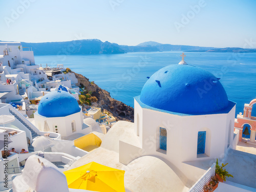 Santorini, Greece. Small narrow streets and rooftops of houses, churches and hotels. Oia village, Santorini Island, Greece. Travel and vacation photography.