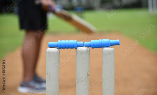 view from behind the wicket of an outdoor cricket training field, soft and selective focus.