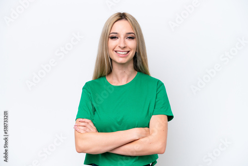 Pretty blonde woman isolated on white background keeping the arms crossed in frontal position