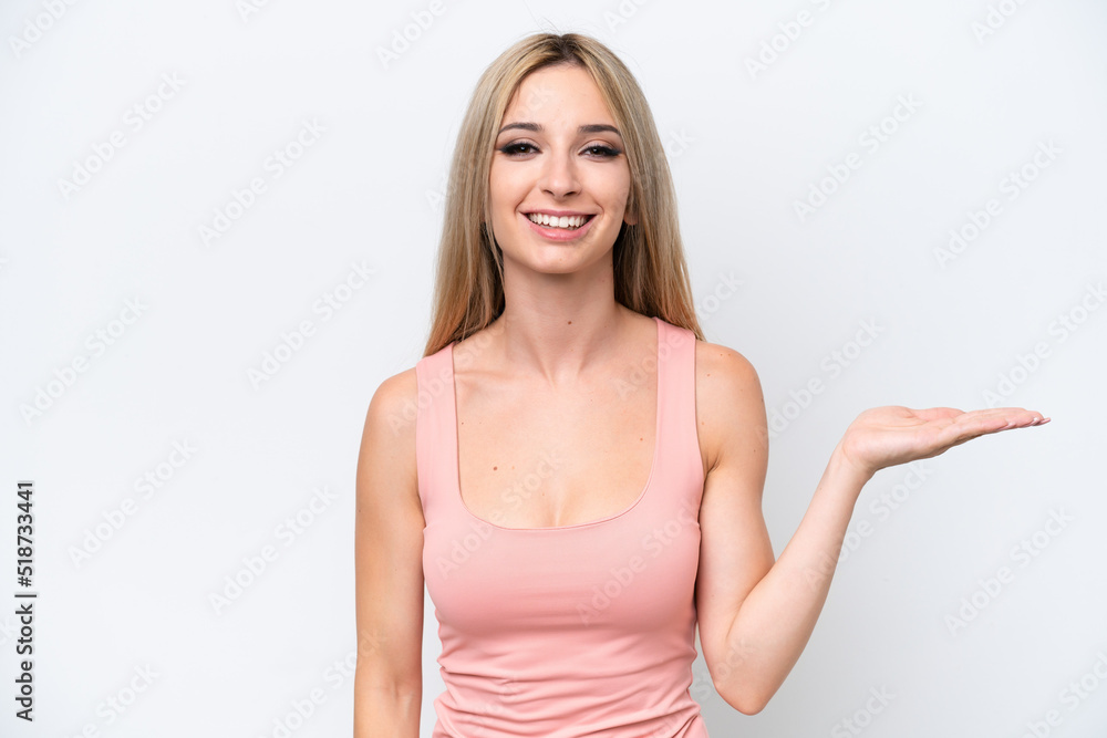 Fototapeta premium Pretty blonde woman isolated on white background holding copyspace imaginary on the palm to insert an ad