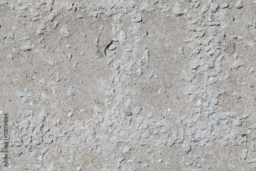 Seamless texture of rough gray concrete with stones