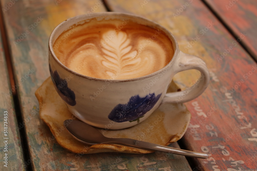 Cappuccino decoration in a ceramic mug with blue decor Cappuccino decoration in a ceramic mug with blue decor