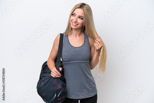 Young sport woman with sport bag isolated on white background thinking an idea