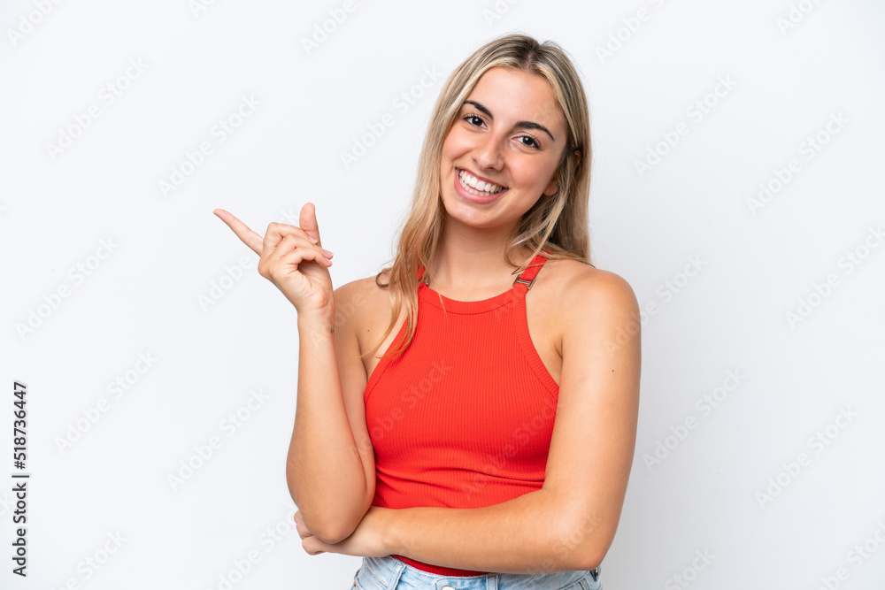 Fototapeta premium Young caucasian woman isolated on white background happy and pointing up
