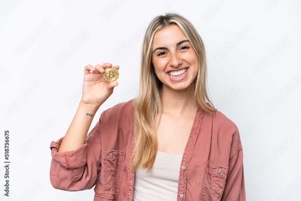 Young caucasian woman holding a Bitcoin isolated on white background smiling a lot Young caucasian woman holding a Bitcoin isolated on white background smiling a lot