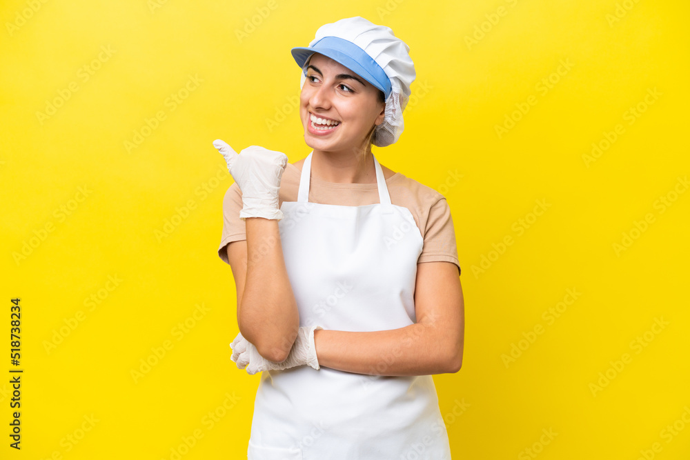 Fishwife woman over isolated background pointing to the side to present a product Fishwife woman over isolated background pointing to the side to present a product