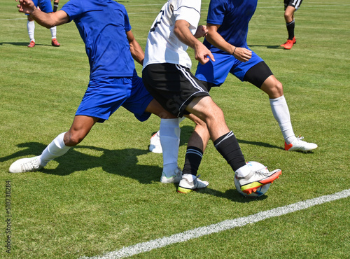Soccer players in action outdoor match photo