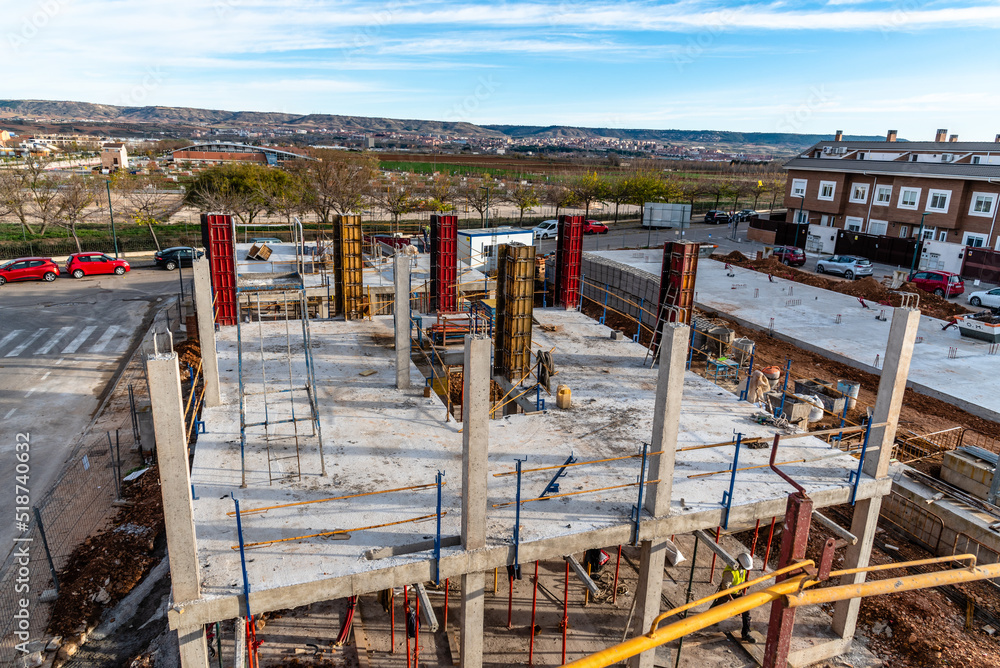 Concrete floor slab with rebars in a residential building under construction. Construction industry and real estate market Concrete floor slab with rebars in a residential building under construction. Construction industry and real estate market