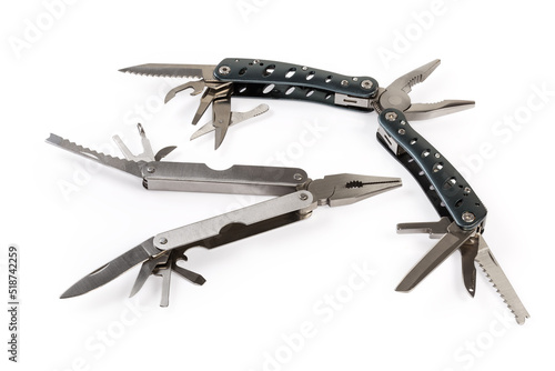 Two multi-tools with open different tools on white background