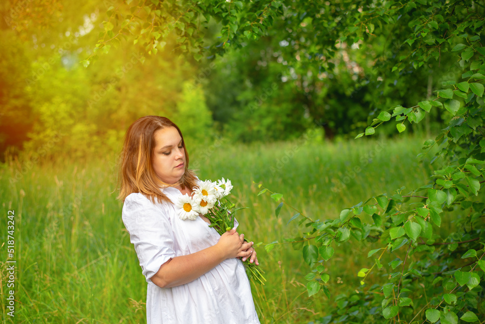 Portrait of a beautiful girl in a white dress in the park on a summer day. Portrait of a beautiful girl in a white dress in the park on a summer day.