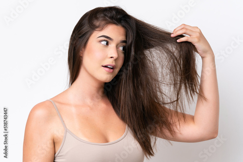 Young Brazilian woman isolated on white background with tangled hair. Close up portrait