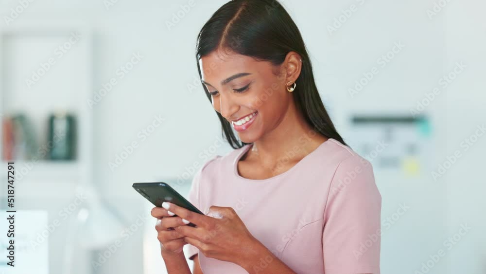 Laughing business woman texting on a phone in an office. Confident, cheerful and happy young entrepreneur smiling while networking with clients and reading messages with good news Laughing business woman texting on a phone in an office. Confident, cheerful and happy young entrepreneur smiling while networking with clients and reading messages with good news