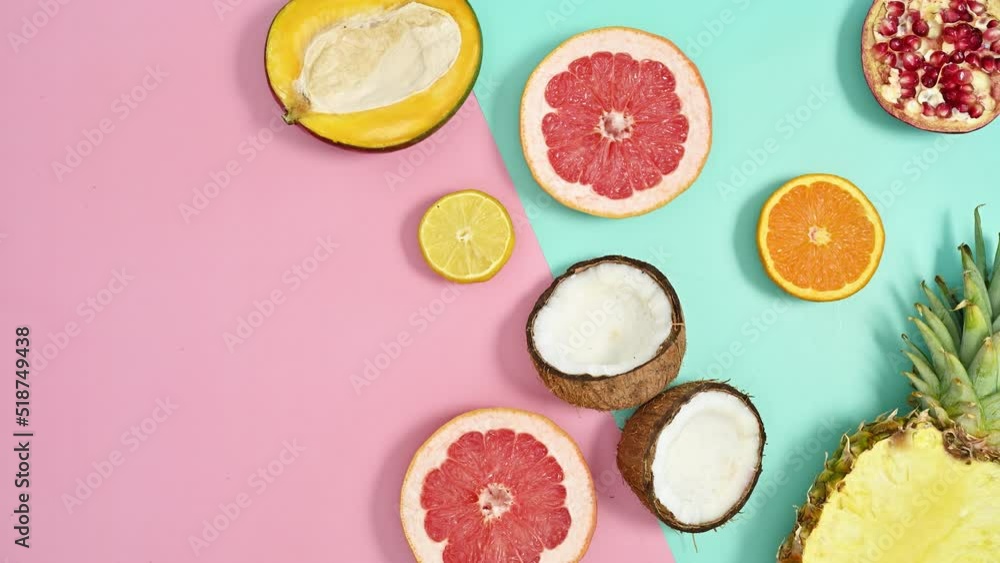 Tropic fruits make summer exotic arrangement on cyan and pastel pink background. Stop motion copy space Tropic fruits make summer exotic arrangement on cyan and pastel pink background. Stop motion copy space