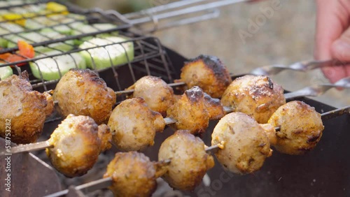 Vegetable mushroom kebab is prepared on the grill. Delicious and juicy grilled vegetables are the tastiest healthy food prepared in the summer outdoors. Mushrooms fried on fire. Rest and picnic. photo