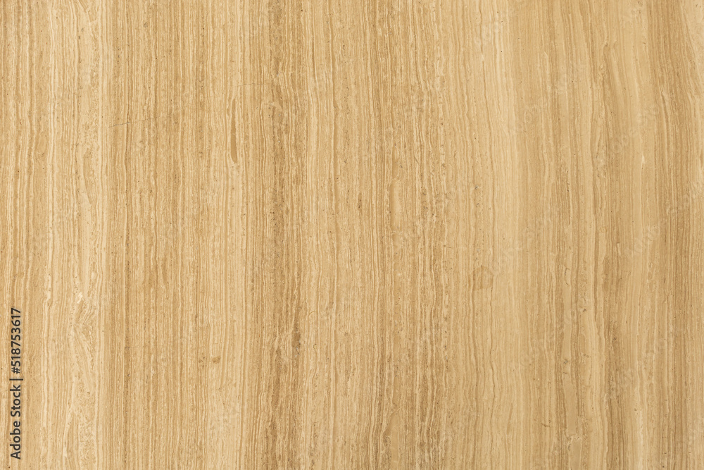 A vertical, straight-lined, light brown pattern of a marble slab. A vertical, straight-lined, light brown pattern of a marble slab.