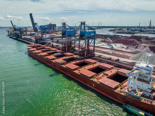 Bulk Carrier Ship Offloading Cargo By Crane for Processing