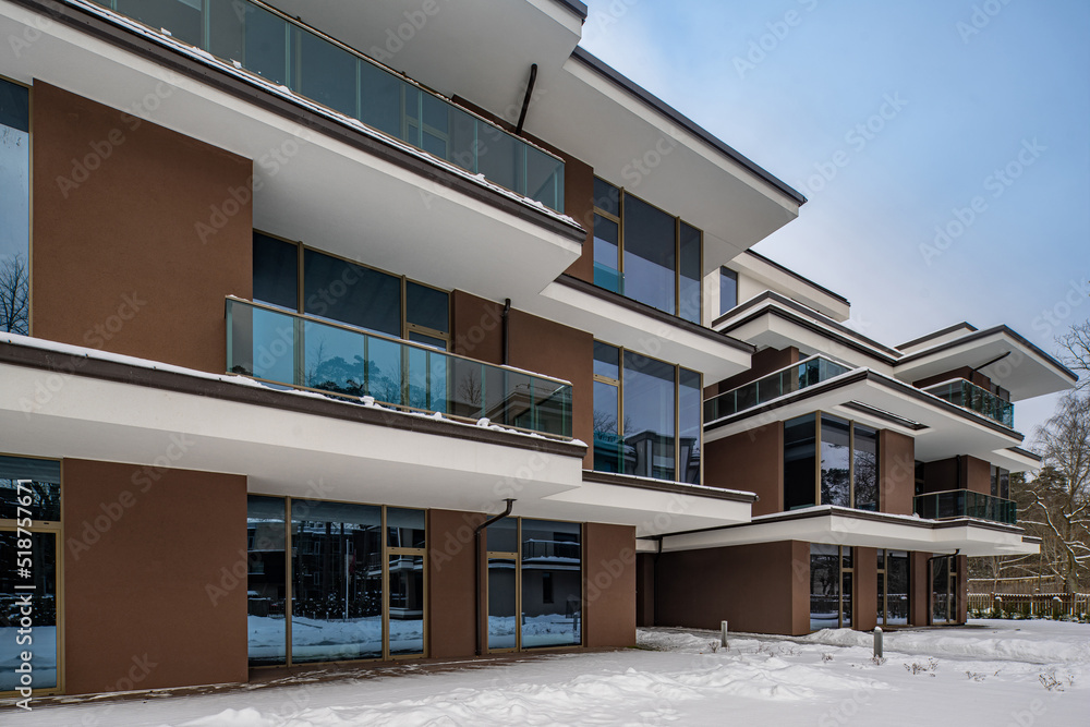 Modern exterior of new luxury residential building at winter.