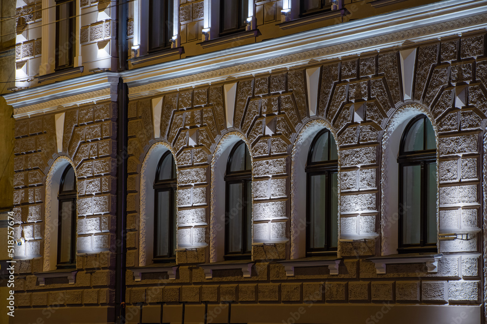 Modern illuminated residential building. Detail of exterior.