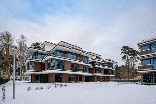 Modern exterior of new luxury residential building at winter.
