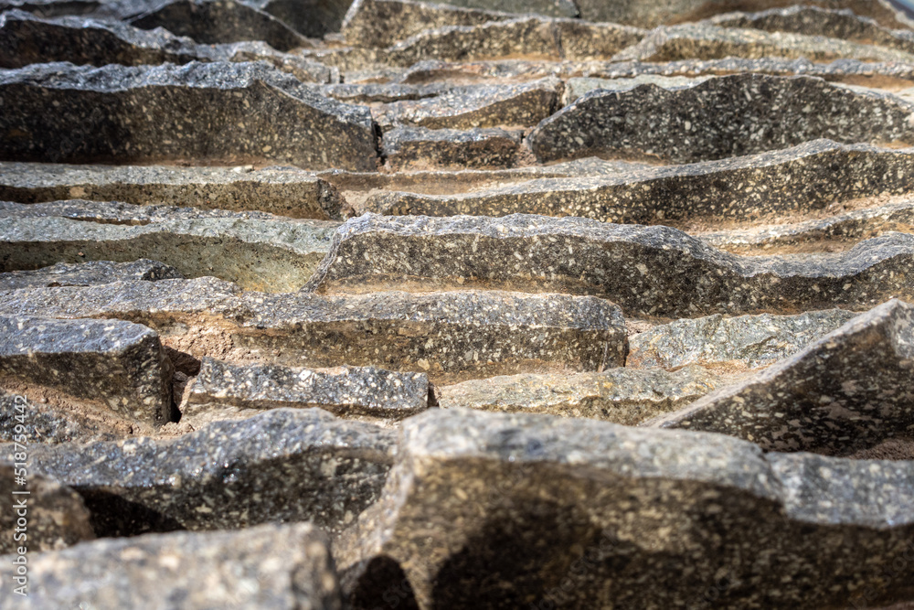 An abstract close up vertical view of a flat rocks stack, that is assembled as a simulation of natural decoration. An abstract close up vertical view of a flat rocks stack, that is assembled as a simulation of natural decoration.
