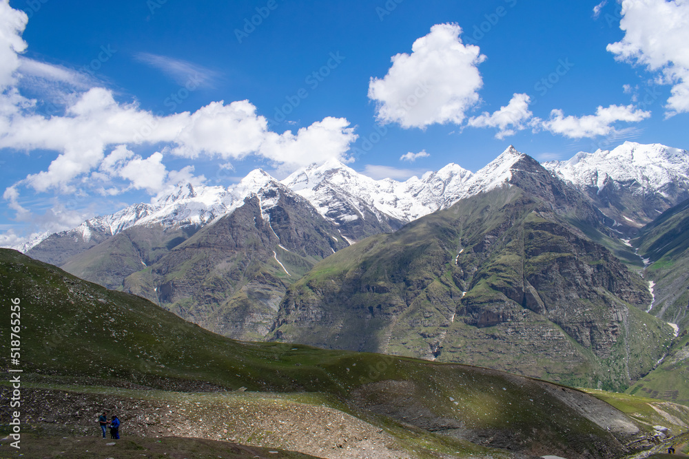 Amazing view of spectacular snow covered himalayas enroute Rohtang Pass,Manali in Himachal pradesh. Beautiful view of snow capped high altitude mountain peaks.Blue skies with clouds and green meadows.