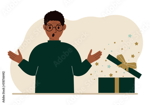 A man next to an open gift. The concept of a holiday, surprise, promotion, discount.