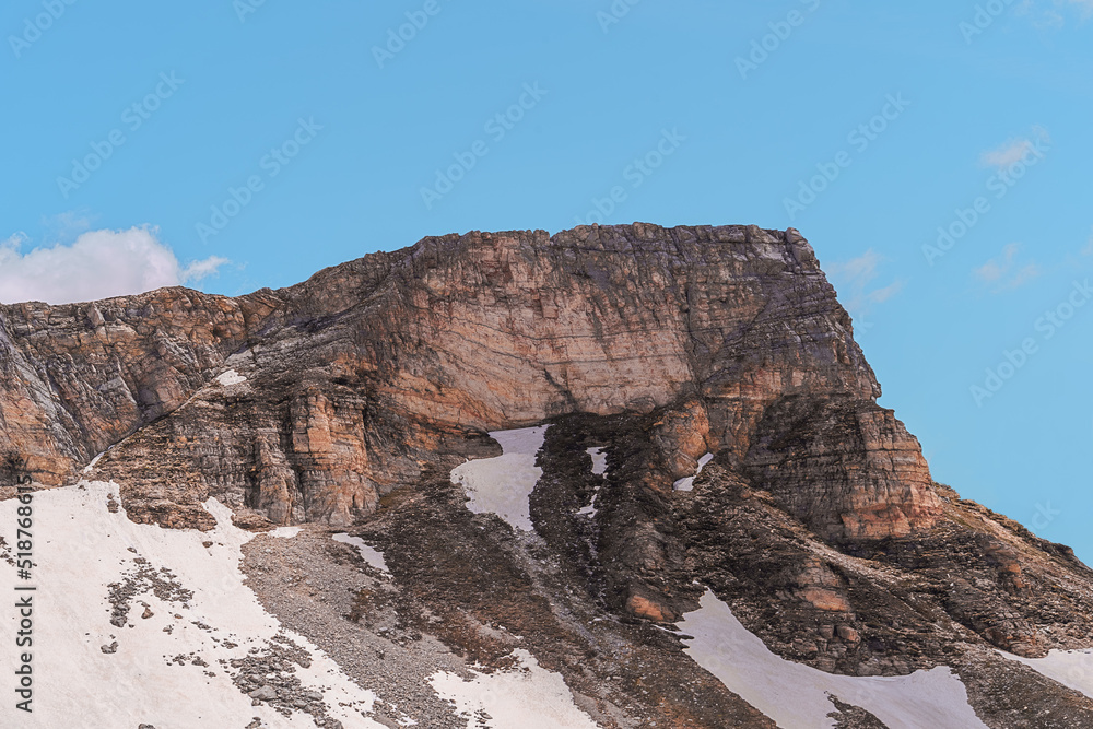 Top of a mountain, big rock, in the alps against blue sky
