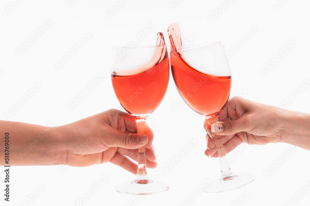 Male and female hands toasting with wine glasses