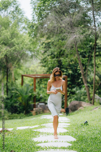 Middle-aged blonde woman at a villa