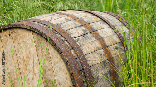 an old oak barrel lying in the grass