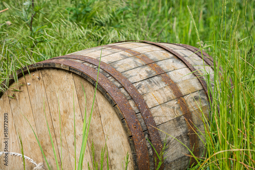 old wooden barrel lying in the grass