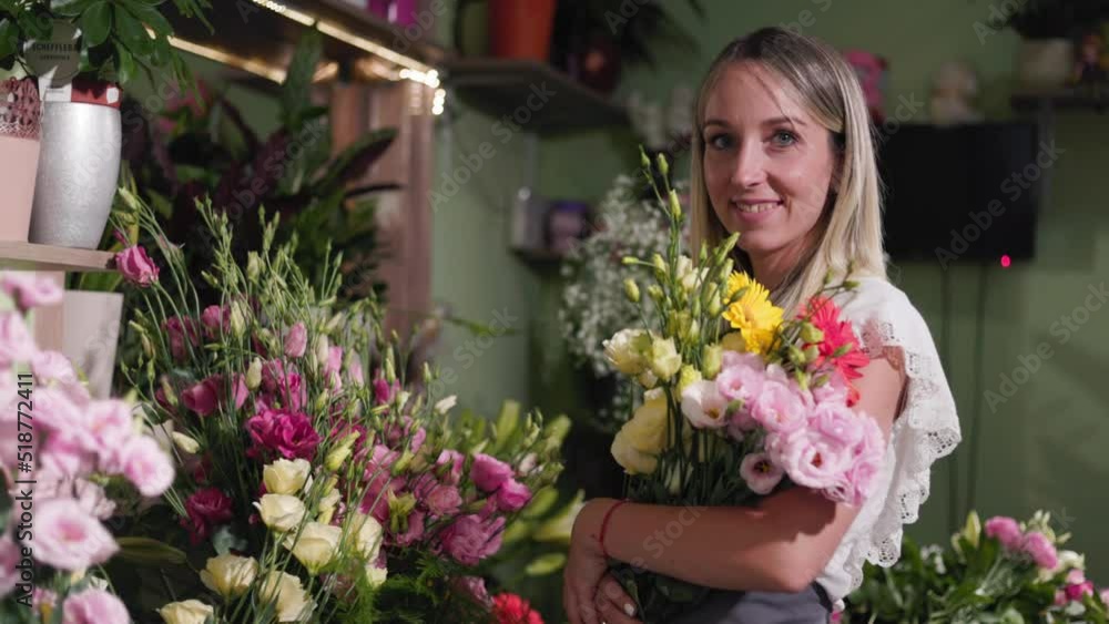 Portrait Of A Beautiful Girl At Her Flower Shop Holding A Plant, Flower. Small business, florst, entrepreneurship concept. Portrait Of A Beautiful Girl At Her Flower Shop Holding A Plant, Flower. Small business, florst, entrepreneurship concept.