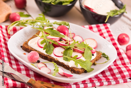 Rye bread with cottage cheese  radish and arugula.