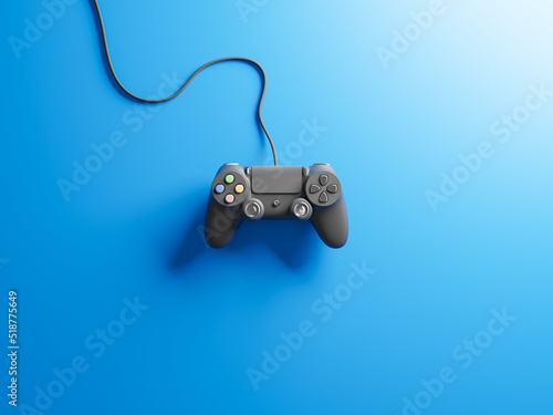 Gamepad with black color and cable, isolated on blue background